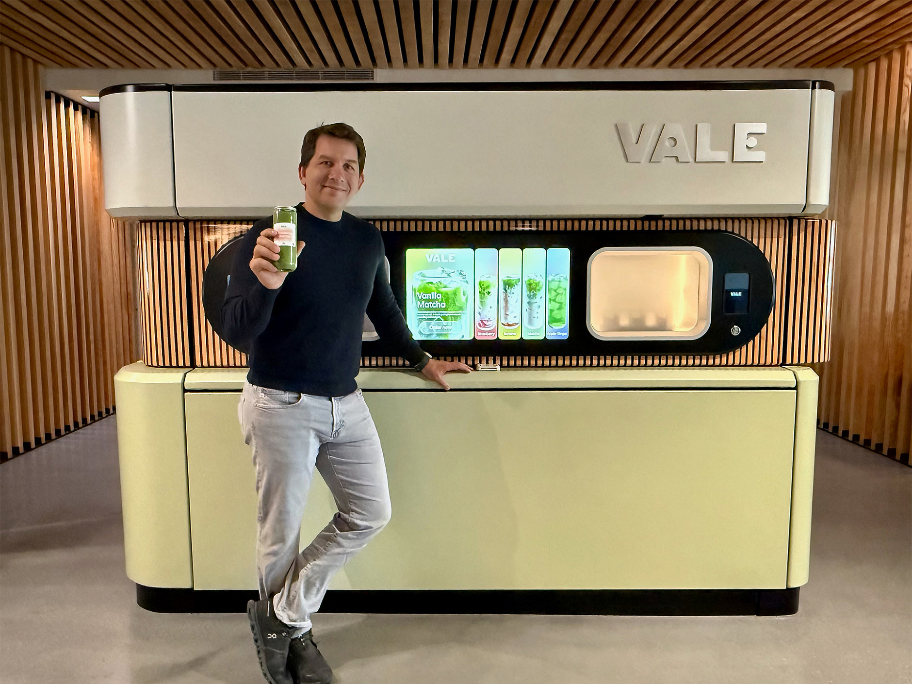 Luke Larson, founder and CEO of Vale, with one of the company’s automated matcha dispenser units in Seattle’s Pioneer Square neighborhood. (GeekWire Photo / Kurt Schlosser)