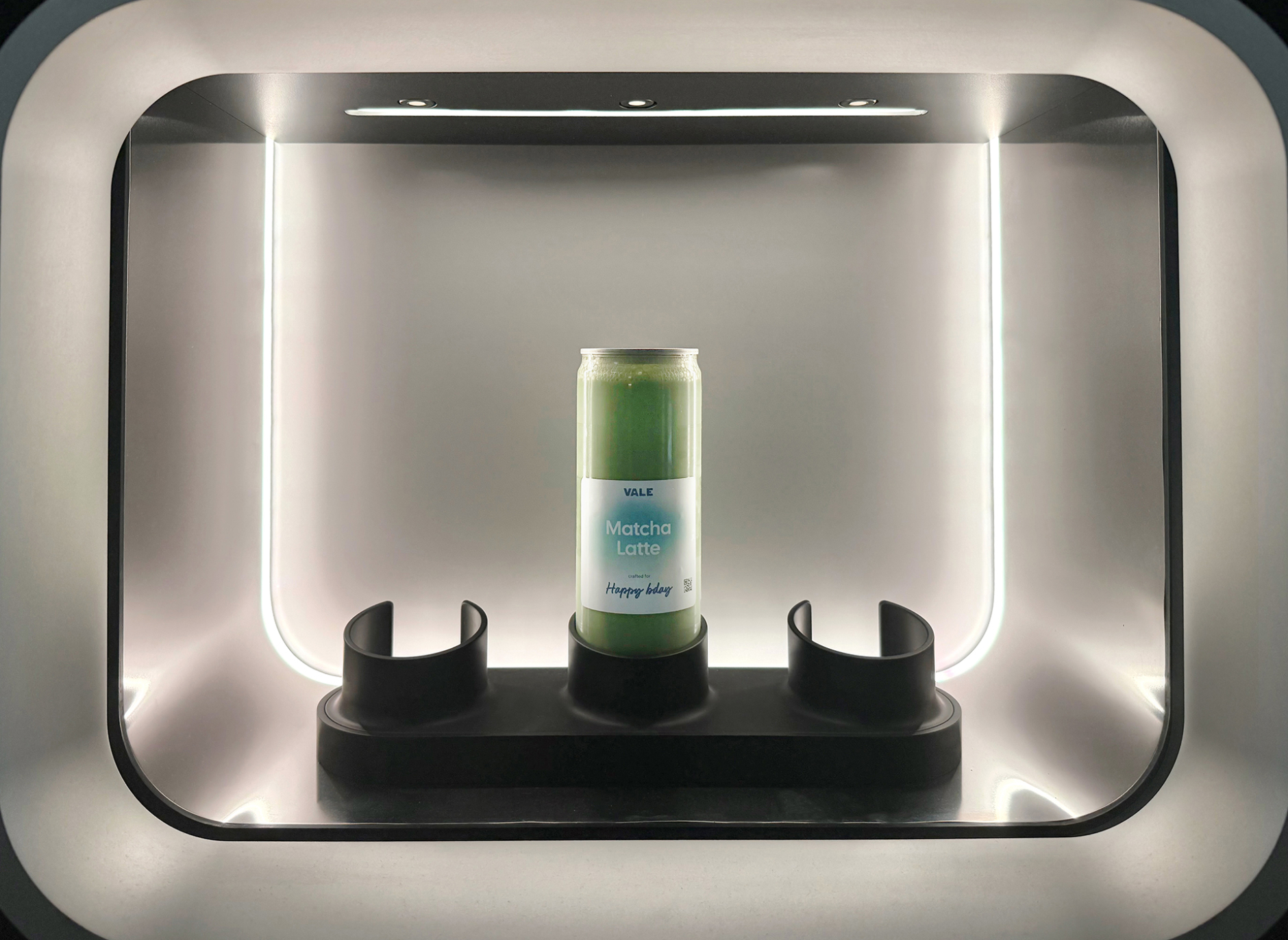 A freshly made matcha latte sitting in the Vale machine pickup portal